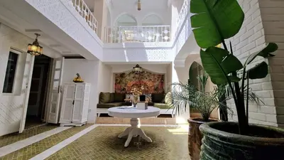 a living room with a table and a couch at Dar Riad Sidi Duri en exclusivité 7 P with private Pools in Marrakech