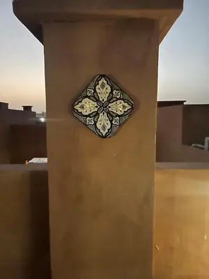 a clock on the side of a wall at Duplex Le Vizir for 6 with Park Access 3 Pools in Dar Caïd Layadi