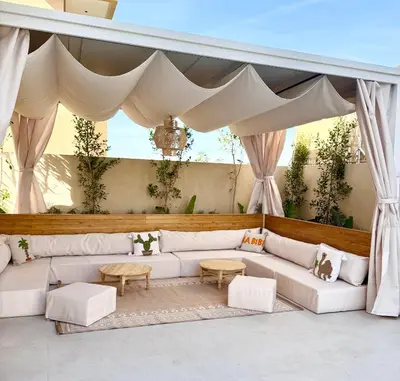 a living room with white couches and a canopy at Villa 289- Charme Balinais in Marrakech