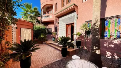 a courtyard with potted plants and a building at Villa Marrakech in Marrakech