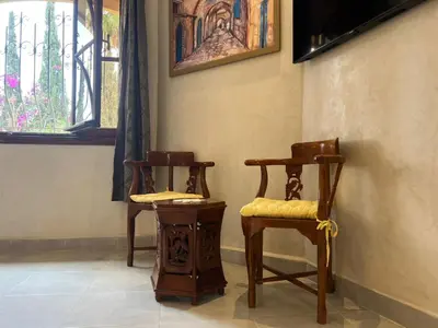 two chairs sitting in a room with a window at ksar el bahja in Marrakech