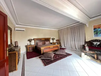 a bedroom with a bed and two rugs at ksar el bahja in Marrakech