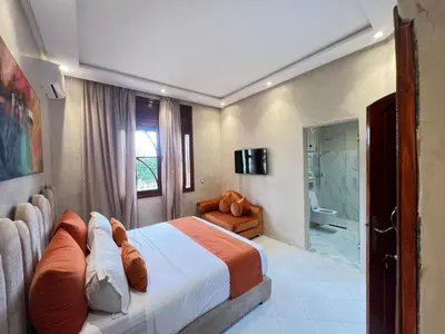 a hotel room with a bed and a bathroom at ksar el bahja in Marrakech