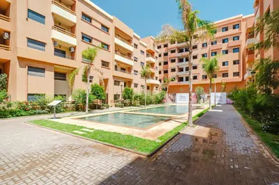 an apartment with a swimming pool in a building at Charming Apartment Guéliz Pool-Parking 24h-7j Security 10 a pied de M Avenue in Marrakech