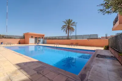 a swimming pool with blue water in a yard at Majorelle Cozy Apartment Garden 2-Balcony Downtown in Marrakech