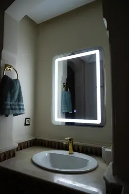 a bathroom with a sink with a large mirror at Hivernage, piscine & jardin privé in Marrakech