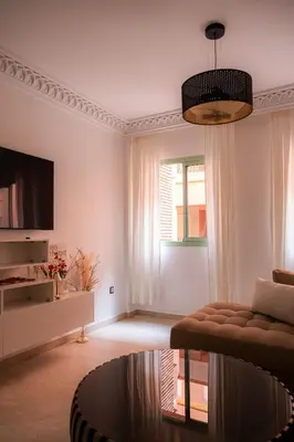 a living room with a couch and a table at Hivernage, piscine & jardin privé in Marrakech