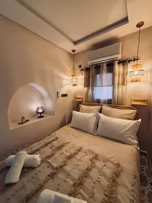 a bedroom with a large bed in a room at DAR ZINA - Heart of Medina, Marrakech in Marrakech