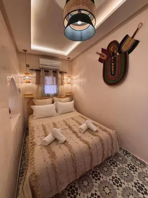 a bedroom with a bed with two towels on it at DAR ZINA - Heart of Medina, Marrakech in Marrakech
