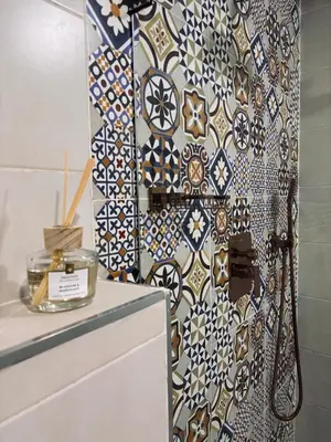 a bathroom with a wall covered in tiles at DAR ZINA - Heart of Medina, Marrakech in Marrakech