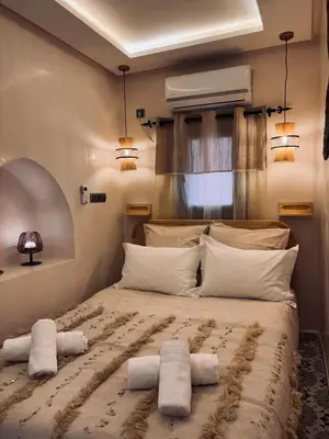 a bedroom with a large bed with towels on it at DAR ZINA - Heart of Medina, Marrakech in Marrakech