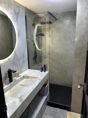 a bathroom with a shower and a sink at MY LOCANA - Appartement Gueliz Jaccuzi in Marrakech
