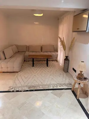 a living room with a couch and a table at MY LOCANA - Appartement Gueliz Jaccuzi in Marrakech
