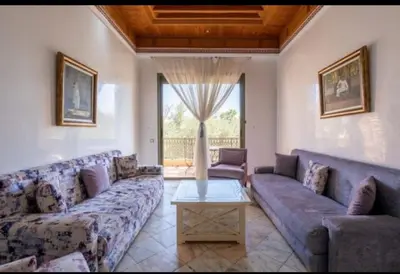 a large living room with couches and a table at Palmeraie Village 2 in Marrakech