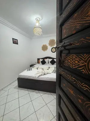 a bedroom with a bed in a room with a door at Riad Four Rooms & Pool in Marrakech