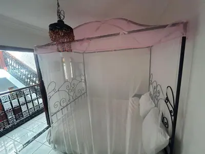a bed with a canopy in a room at Riad Four Rooms & Pool in Marrakech