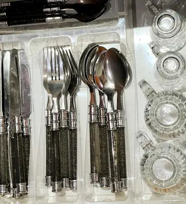 a plastic container with forks and spoons and other utensils at perle studio familial in Marrakech
