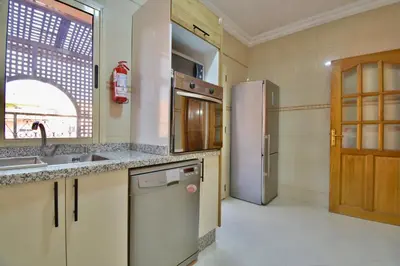 a kitchen with a sink and a refrigerator at Appartement Les Huit Palmiers in Marrakech
