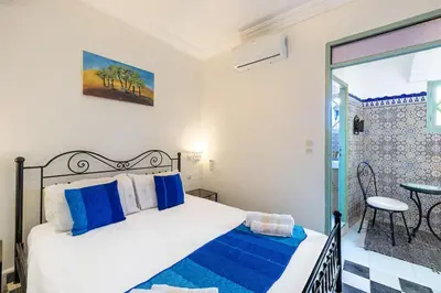 a bedroom with a bed and a table and a window at 2BR Medina Home with Roof Terrace in Marrakech
