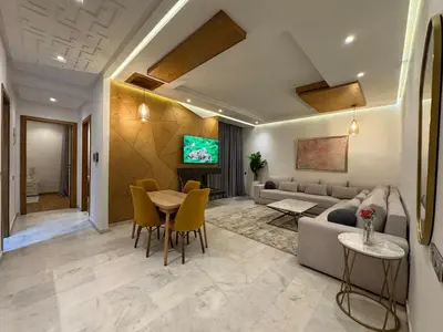 a living room with a couch and a table and chairs at Luxury Retreat 2Bdr Appartment In Prime Marrakech in Marrakech