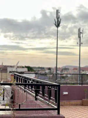a metal railing on a balcony with a view of a city at Apartment with rooftop access in Marrakech