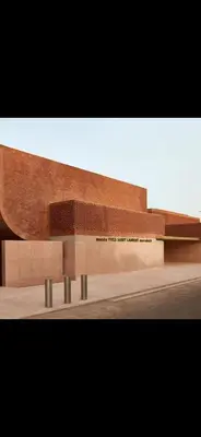 a brick building with benches in front of it at Rouge Mamounia in Marrakech