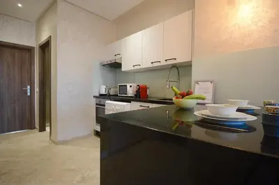 a kitchen with a counter with a bowl of fruit on it at Central location-Queensize bed- Parking, AC & Iptv in Marrakech
