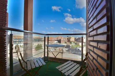 a balcony with two chairs and a table on a balcony at Central location-Queensize bed- Parking, AC & Iptv in Marrakech