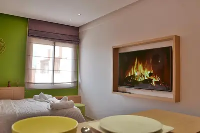 a living room with a fire in the wall at 1BR Studio-AC & IpTV-Downtown Gueliz-perfect for 2 in Marrakech