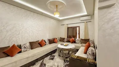 a living room with a couch and a table at Apartment near the airport in Marrakech