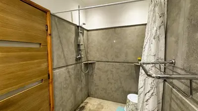 a bathroom with a shower with a shower curtain at Apartment near the airport in Marrakech