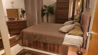 a bedroom with a bed with pillows on it at Achraf in Marrakech