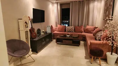 a living room with a couch and a guitar at Achraf in Marrakech