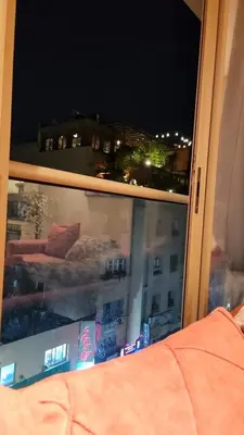 a window with a view of a city at night at Achraf in Marrakech