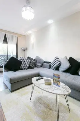 a living room with a couch and a table at Atlas Golf Resort - piscine - rooftop in Marrakech