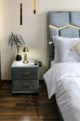 a bedroom with a bed and a nightstand with a lamp at Atlas Golf Resort - piscine - rooftop in Marrakech