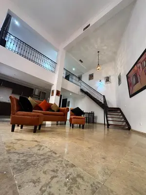 a living room with two couches and a staircase at Duplexe Mirador Majorelle in Marrakech