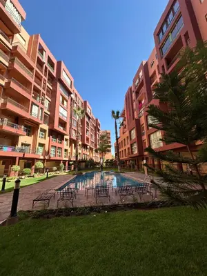 a courtyard with tables and chairs in front of buildings at Duplexe Mirador Majorelle in Marrakech