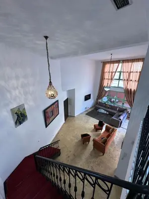an overhead view of a living room with a chandelier at Duplexe Mirador Majorelle in Marrakech