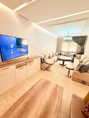 a large living room with a large flat screen tv at Luxueux Aprt A Gat Moderne Centre-ville in Marrakech