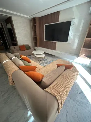 a living room with a couch with pillows at Appartement avec piscine Marrakech in Marrakech