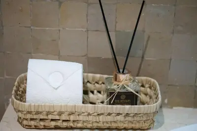 a basket with toiletries and a candle on a table at Peaceful 2BR Oasis with Pool Tennis AC - Palmeraie in Marrakech