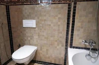 a bathroom with a toilet and a sink at Peaceful 2BR Oasis with Pool Tennis AC - Palmeraie in Marrakech