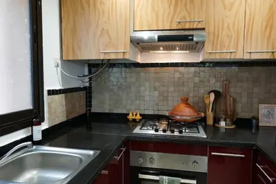 a kitchen with a sink and a stove top oven at Peaceful 2BR Oasis with Pool Tennis AC - Palmeraie in Marrakech