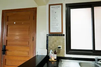 a kitchen with a sink and a wooden door at Peaceful 2BR Oasis with Pool Tennis AC - Palmeraie in Marrakech