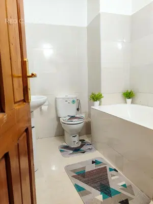 a bathroom with a toilet and a tub and a sink at Eden Orientale in Marrakech