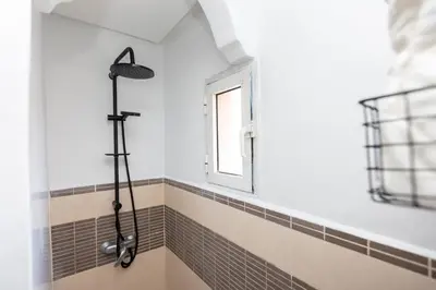 a shower in a bathroom with a window at Modern & Chic Apartment in Gueliz, Marrakech in Marrakech