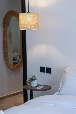 a bedroom with a bed and a table with a mirror at Modern & Chic Apartment in Gueliz, Marrakech in Marrakech