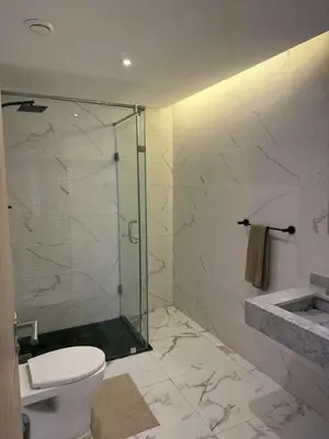 a bathroom with a glass shower and a toilet at Palmeraie Gates in Marrakech