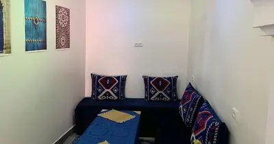 a small room with two pillows and a blue bench at Dar ESSEKIA in Marrakech